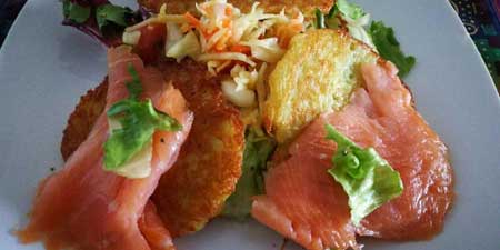 Smoked salmon on potato pancakes - dressed with a colorful salad