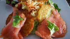 Smoked salmon on potato pancakes - dressed with a colorful salad
